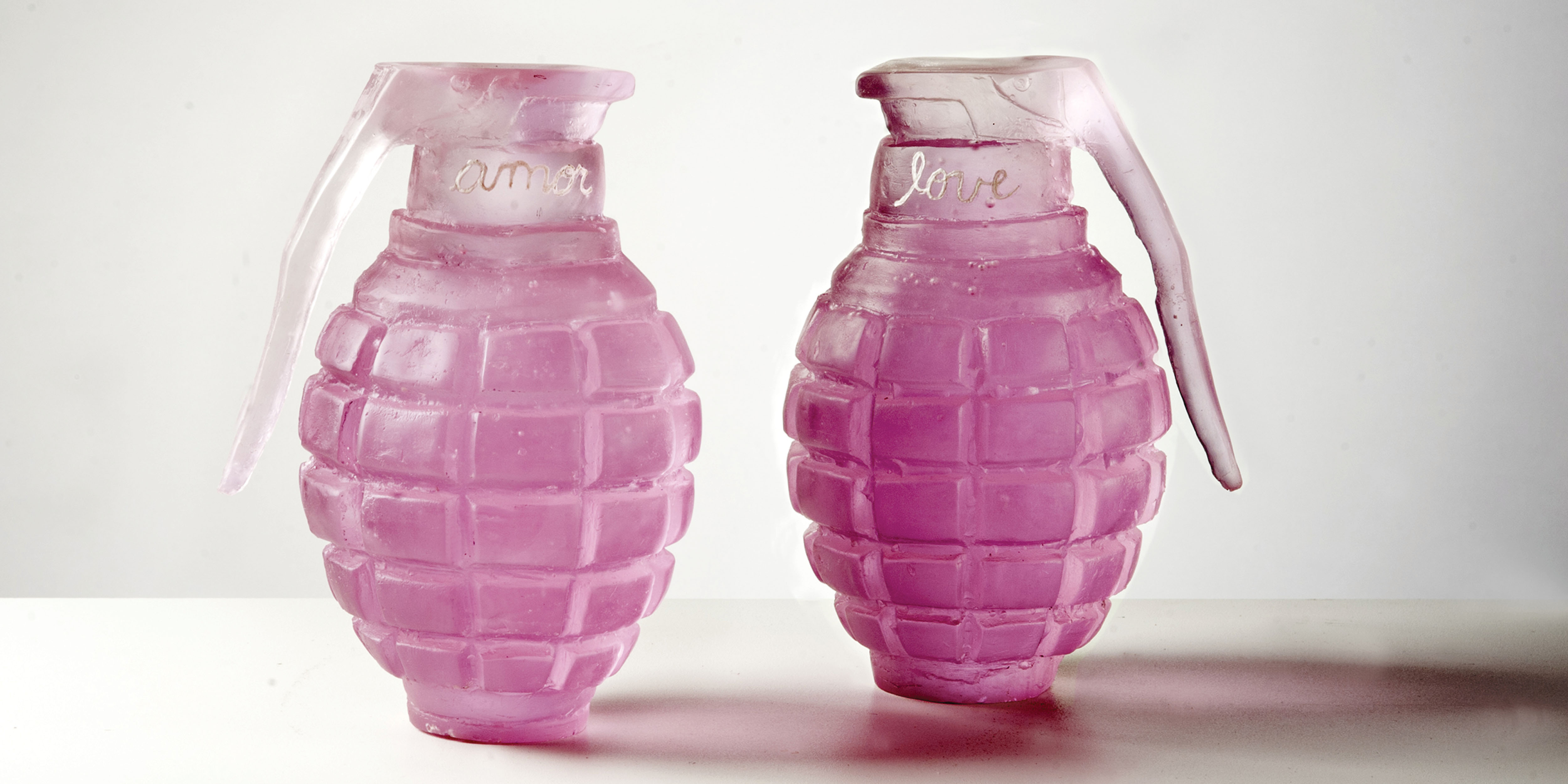 A pair of grenades cast in glass